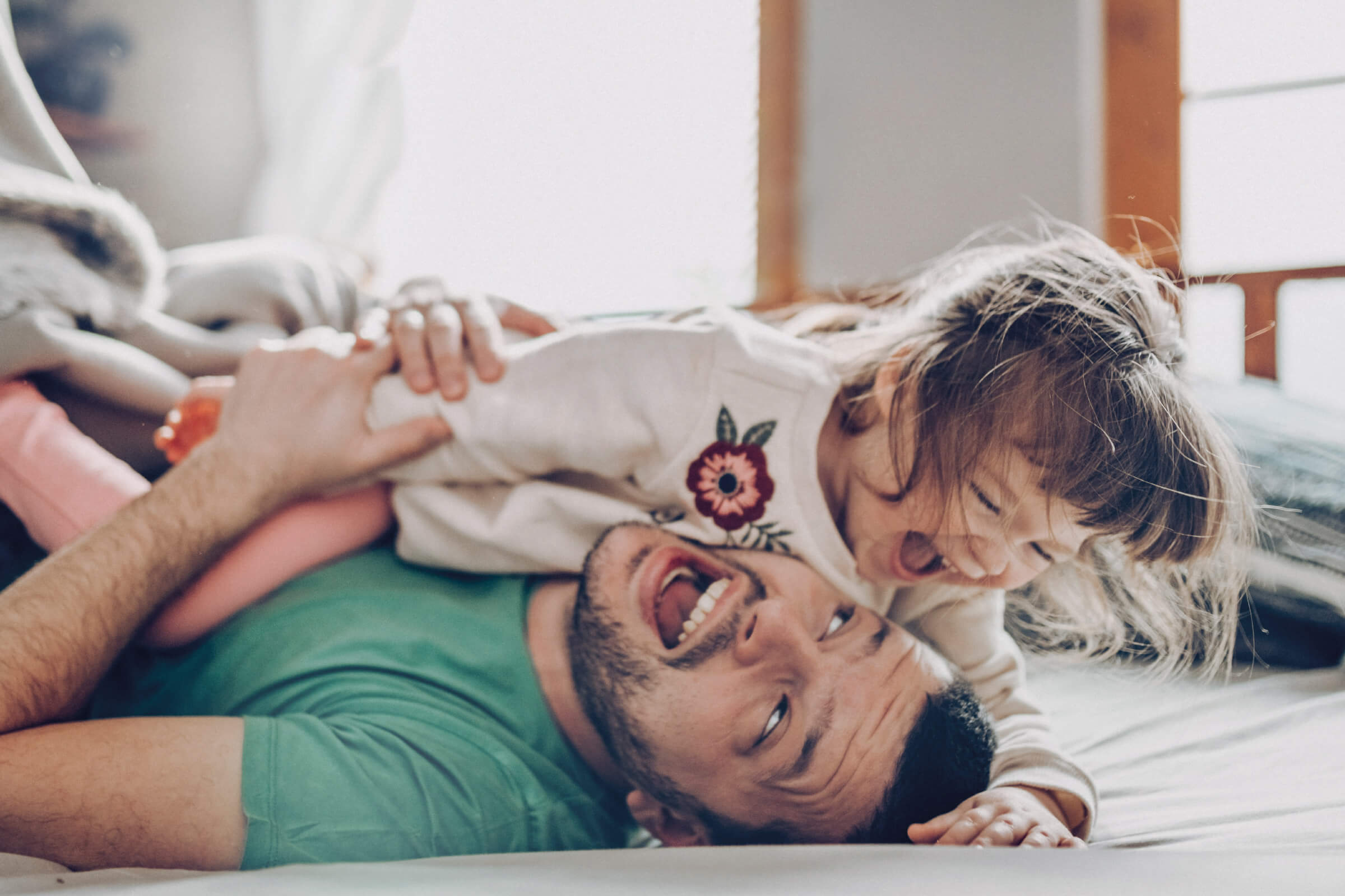 Father playing with laughing child