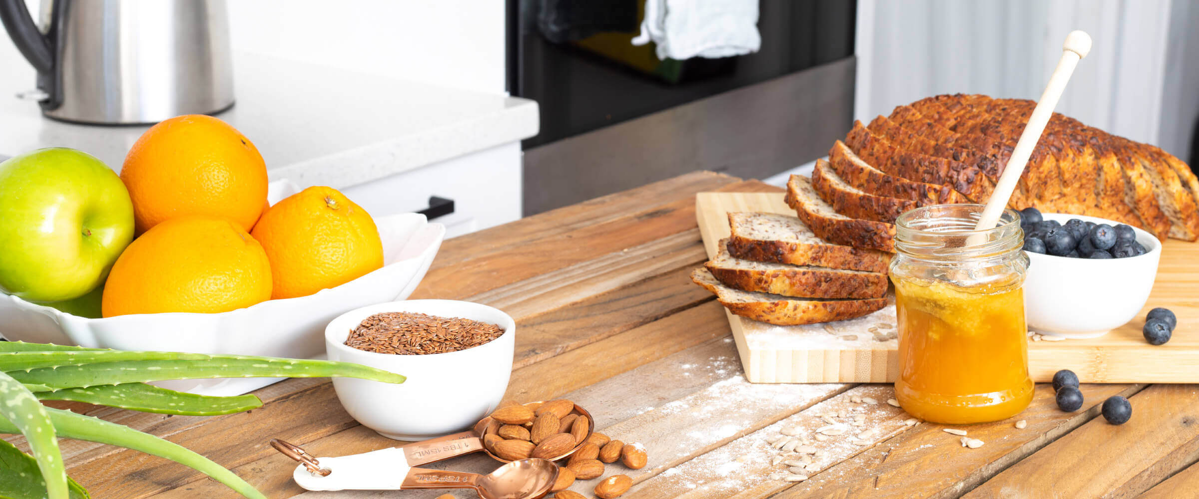 Rustic table with grains, bread, honey and fruit
